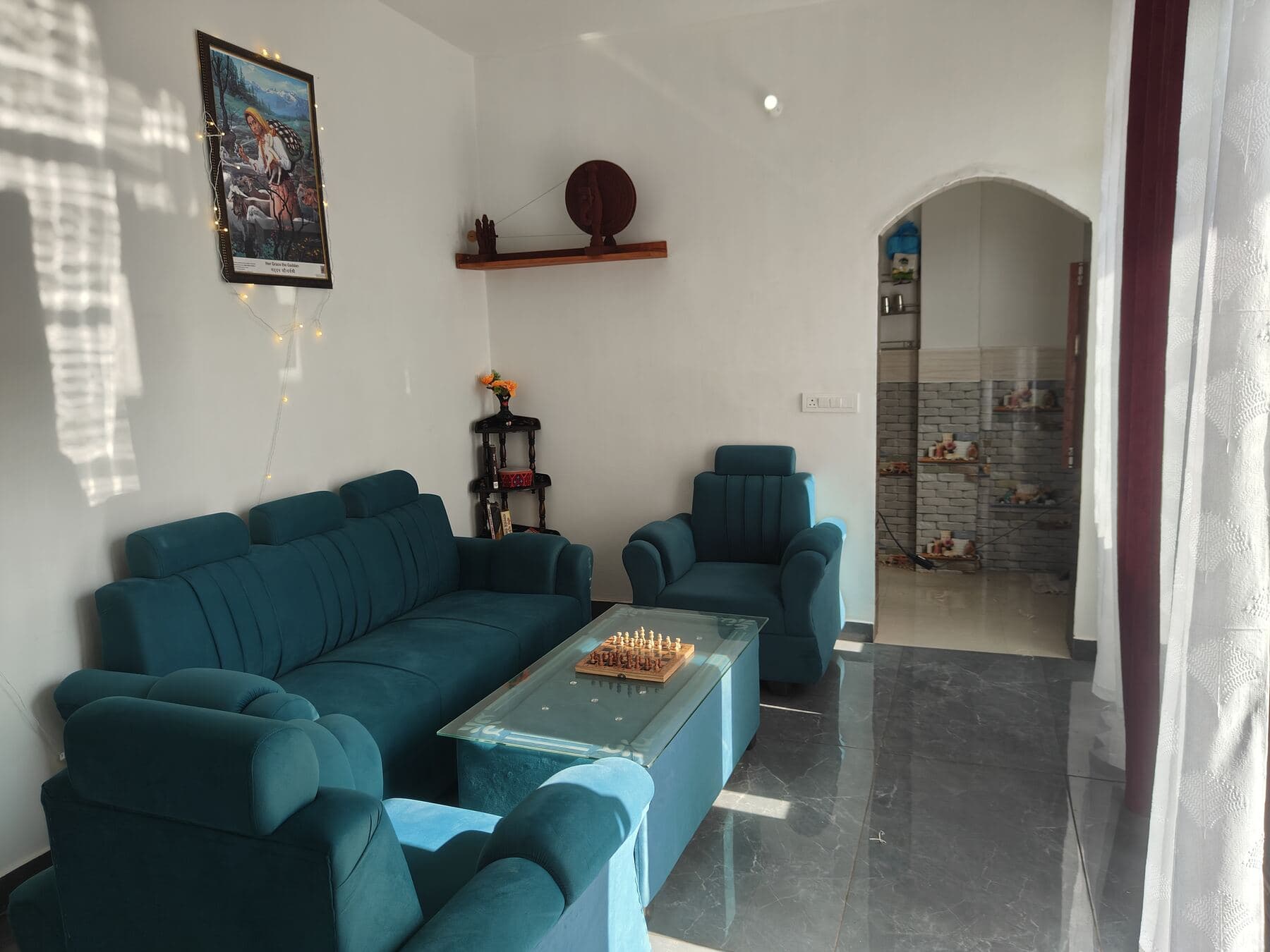 The shared living room with sofas and a chess table.