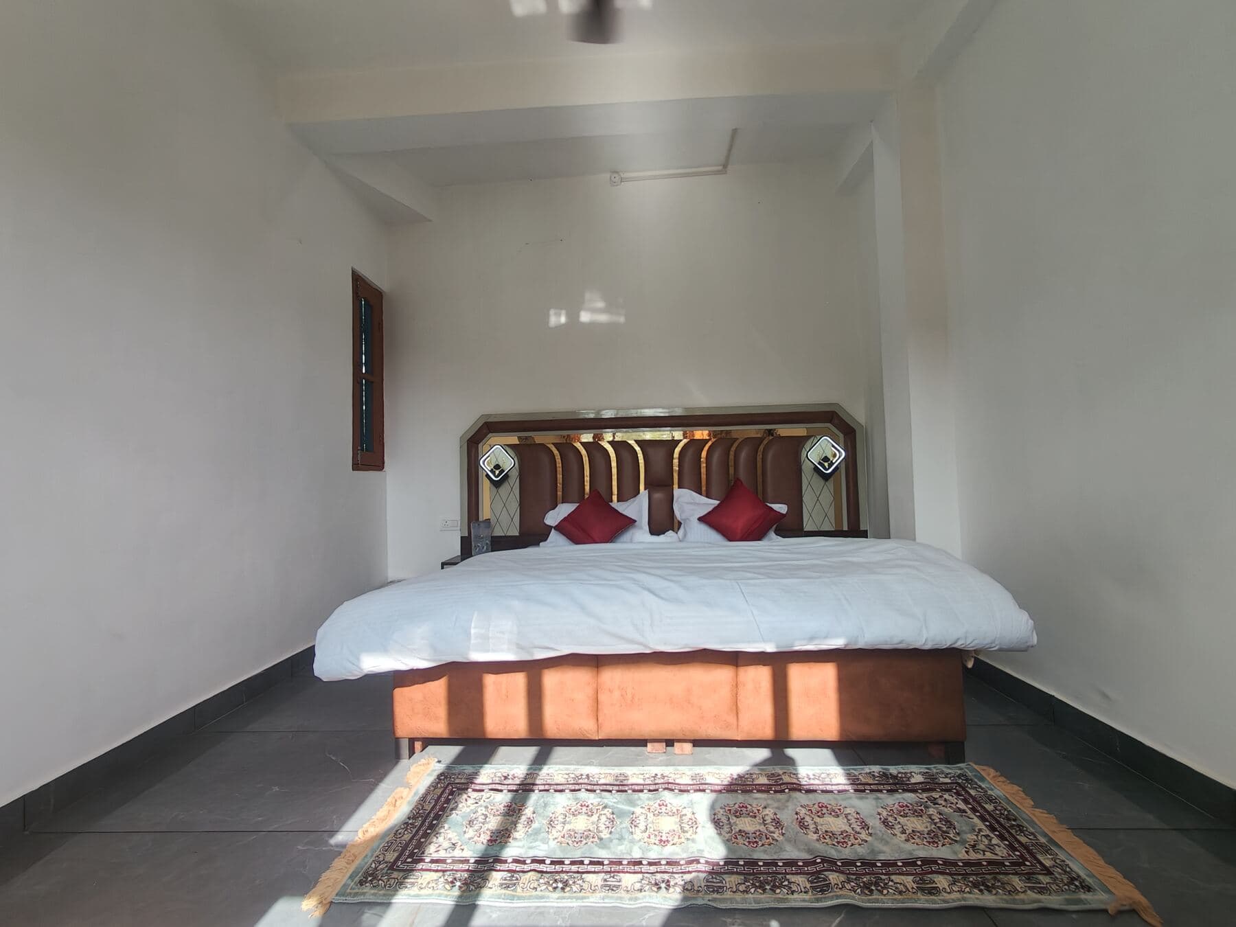 A bright, cozy bedroom in the Signature Himalayan Room.